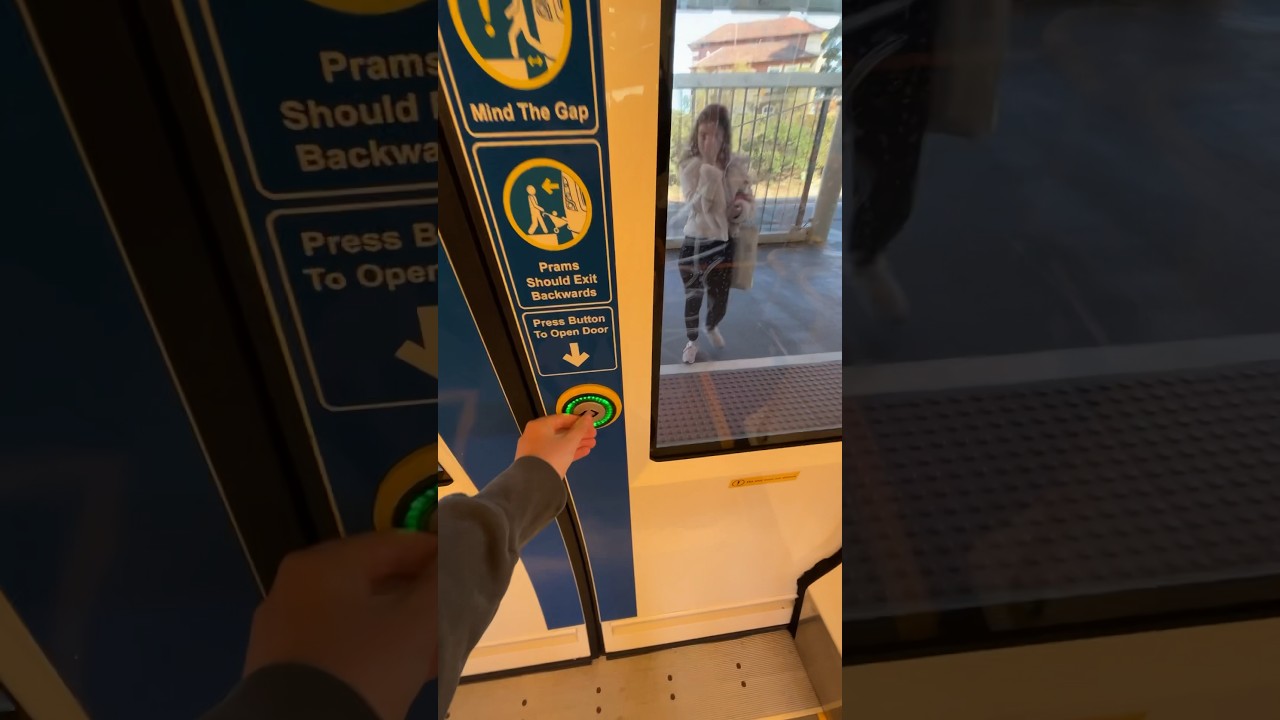 Pressing the button to open doors on an Adelaide train 