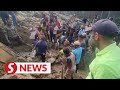 With bare hands and sticks, locals search for survivors in deadly PNG landslide