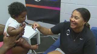 Pro softball star returns to game with young kids in tow