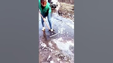 the process of cleaning ice on the road using a shovel #shorts