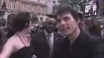 Tom Cruise gets squirted with water by a fan with a fake microphone