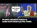 Viral pm modi urges woman to climb down from electric tower during his rally in hyderabad