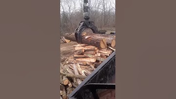 Log truck unloading logs
