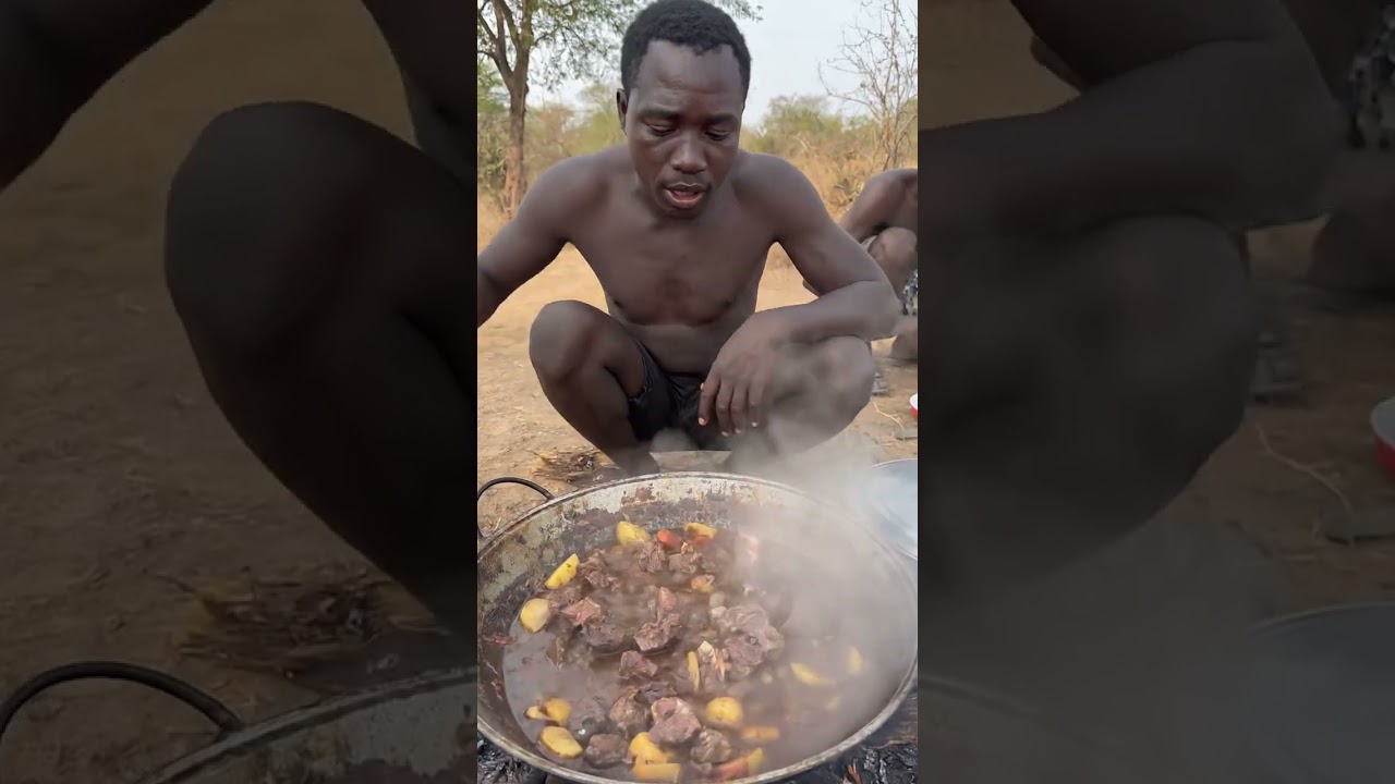 Hadzabe eating roasted meat with smoky campfire taste.