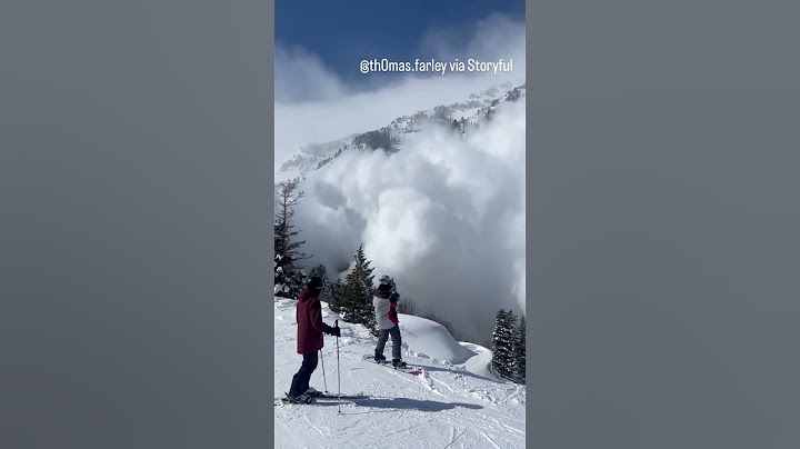 Massive avalanche tumbles toward skiers