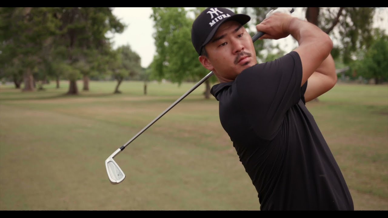 A player mid-swing with a Miura iron