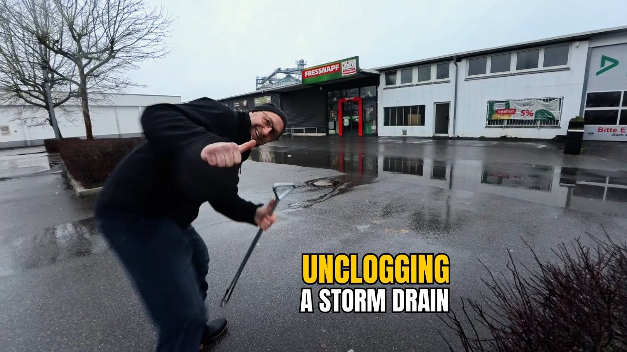 #064-1 Unclogging a storm drain on a parking space after rain in ...