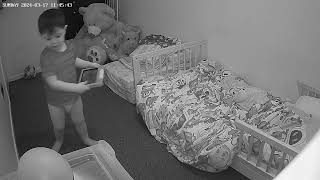 Little boy in diaper spins around in bedroom while holding tablet then falls and bumps head