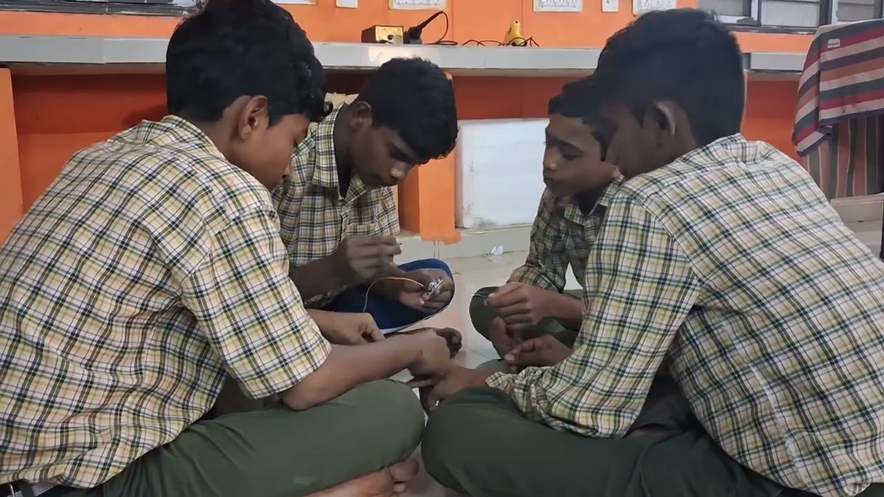 Students building a basic circuit with an IR sensor, buzzer, and breadboard 