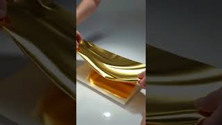 AI ASMR : Shiny gold foil sheets being slowly crinkled