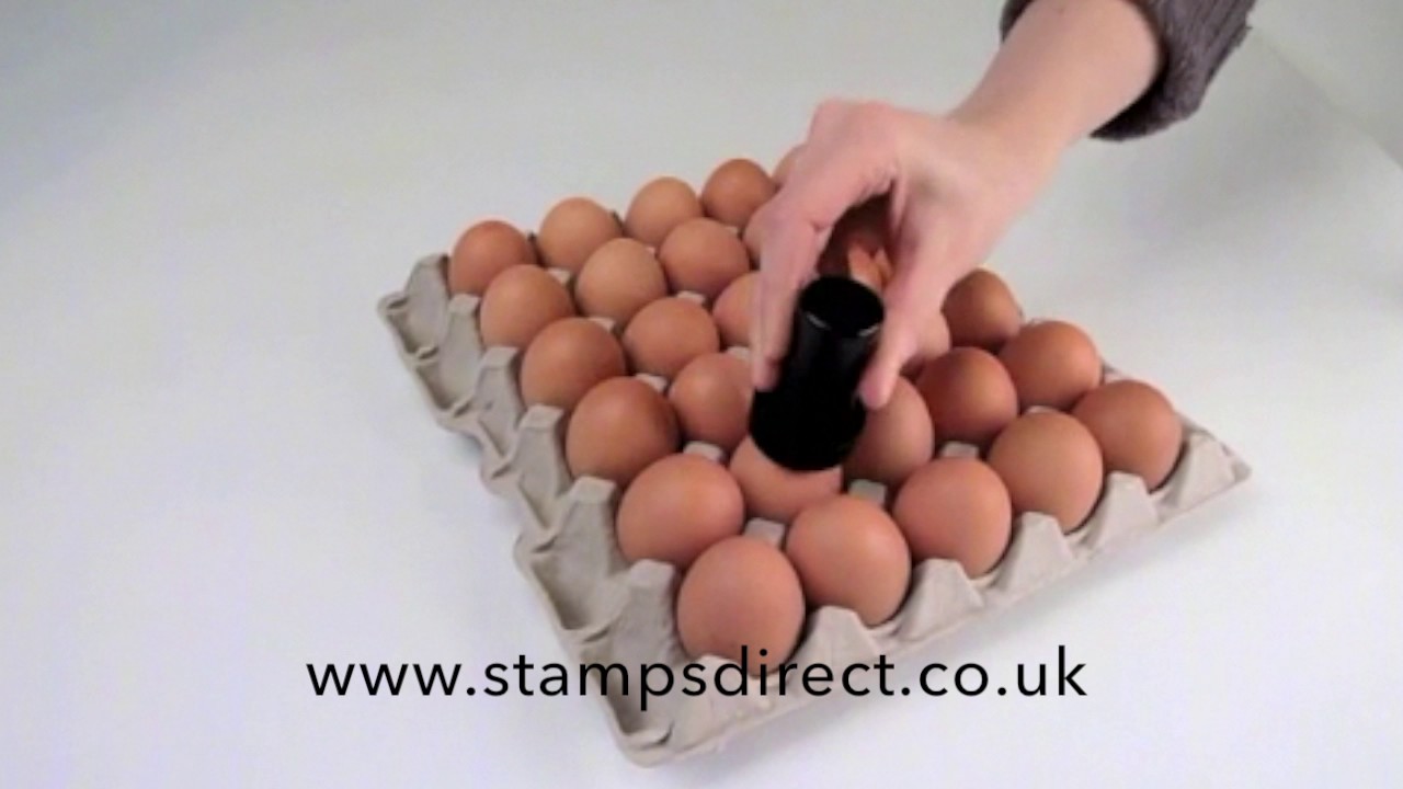 Stamping a tray of eggs 