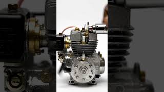 UntitledMacro close-up of a miniature silver model engine with cooling fins and gold-toned component