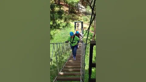 Kelly Denman walking the suspended rope bridge