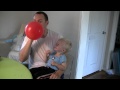 Micah laughing hysterically at balloons