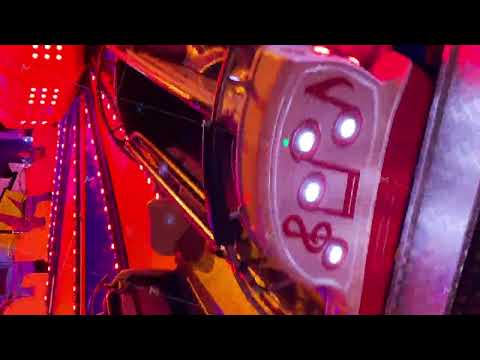 Illuminated beautiful carousel in the amusement park at night. Media. Close-up of an attraction for