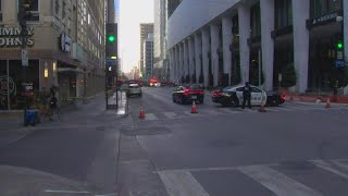Police, fire crews try to keep debris from falling in downtown Dallas due to strong winds