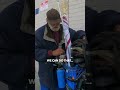 Homeless person giving out cash to strangers