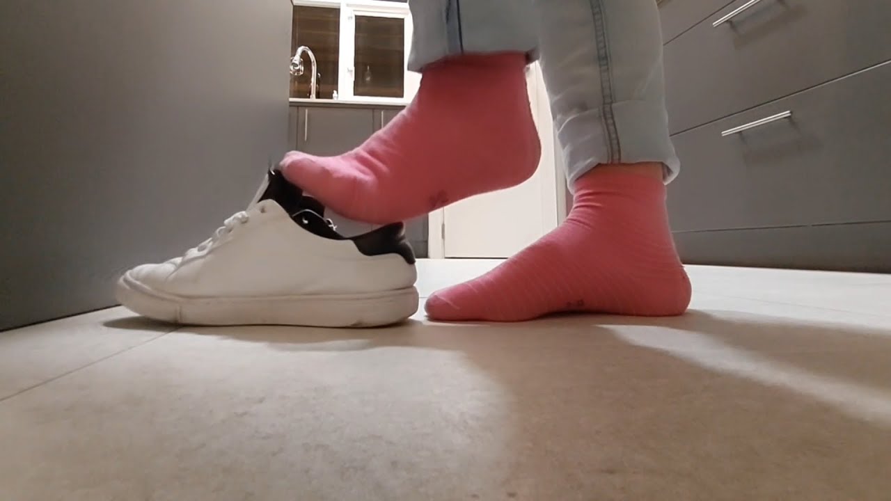 Shoeplay, standing, white Calvin Klein sneakers, pink socks, preparing dinner with friends