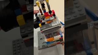 Lego vacuum engine with 8x8 piston and overhead valves in slow motion.