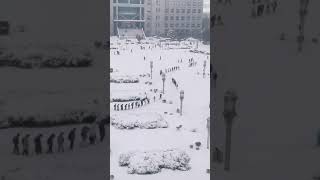 University Students Walk in Snowy Conditions