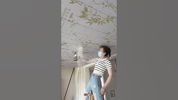 Female carpenter installing suspended ceiling
