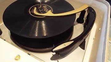 Magnavox record player playing a stack of 78 records