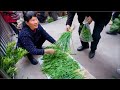 Primitive lifestyle  chinese farmer selling veggies on the village market