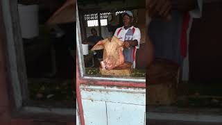 Cutting a pig head Caribbean style