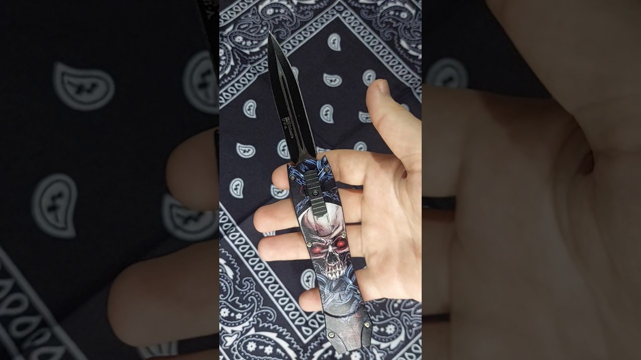 Button knife with skeleton head design