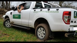 4x4 stuck truck in mud spinning tires offroad in camo pant