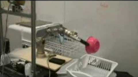 Robot unloads items from a dishwasher.