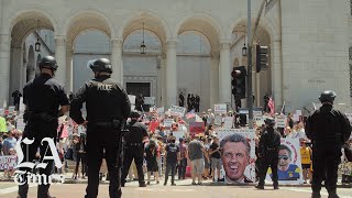 Things get heated as hundreds gather outside city hall in downtown los
angeles to protest stay-at-home orders.the was one of several around
californi...