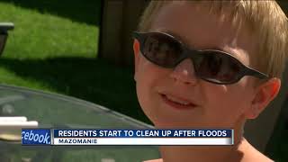 Residents begin to clean up after floods