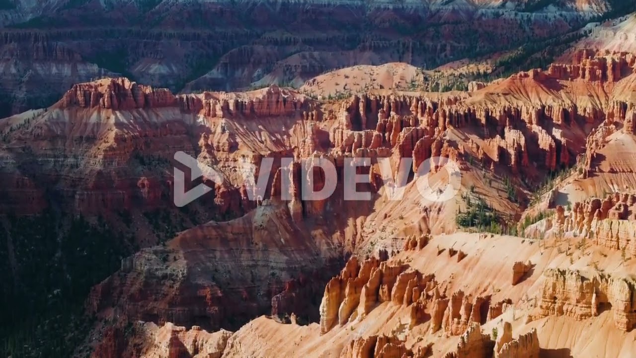Aerial tilt shot of rocky formations in Bryce Canyon, sunny day in Utah, USA
