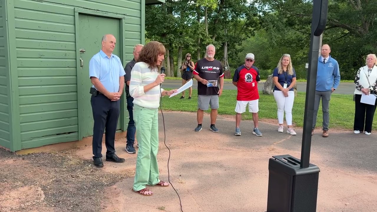 Danielle Krajewski speaks at renaming of Henry Park softball field in honor of her late husband.