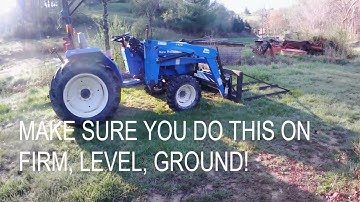 Taking the loader off the New Holland tractor