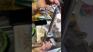 Resizing a ring with a stretcher. This machine mechanically expands the band for a perfect fit.