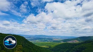 White clouds drift above green hills and forests time lapse, Relax in Nature with „Cloud Observe“