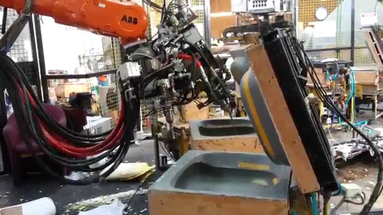 ABB Robot pouring 3 urethane Foam machines into custom mouldings YouTube