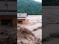 Flood water poured into the street like a river