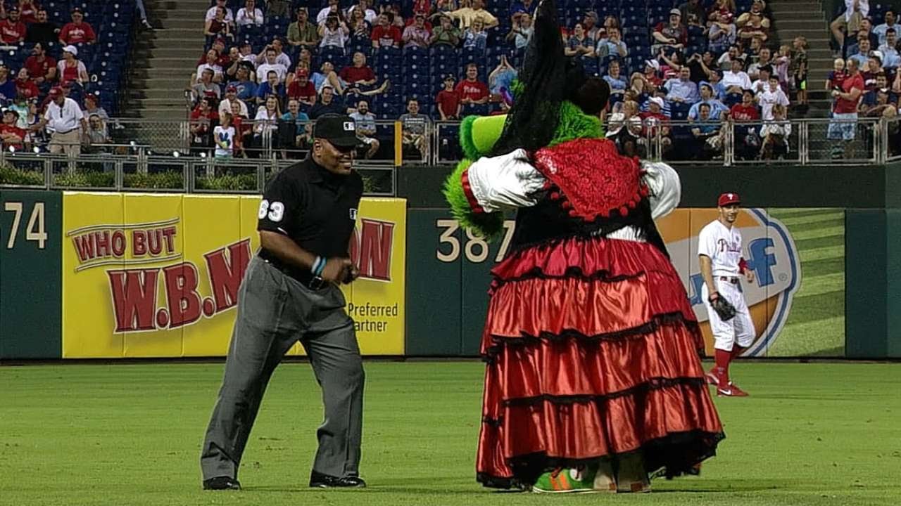 Umpire Laz Diaz dances with the Phanatic