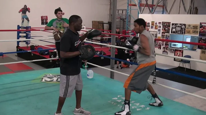 Deaf boxer Raymond Merrill padwork with trainer Je...