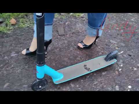 Cindy is Riding Scooter Wearing Hight Heels Shoes Stock