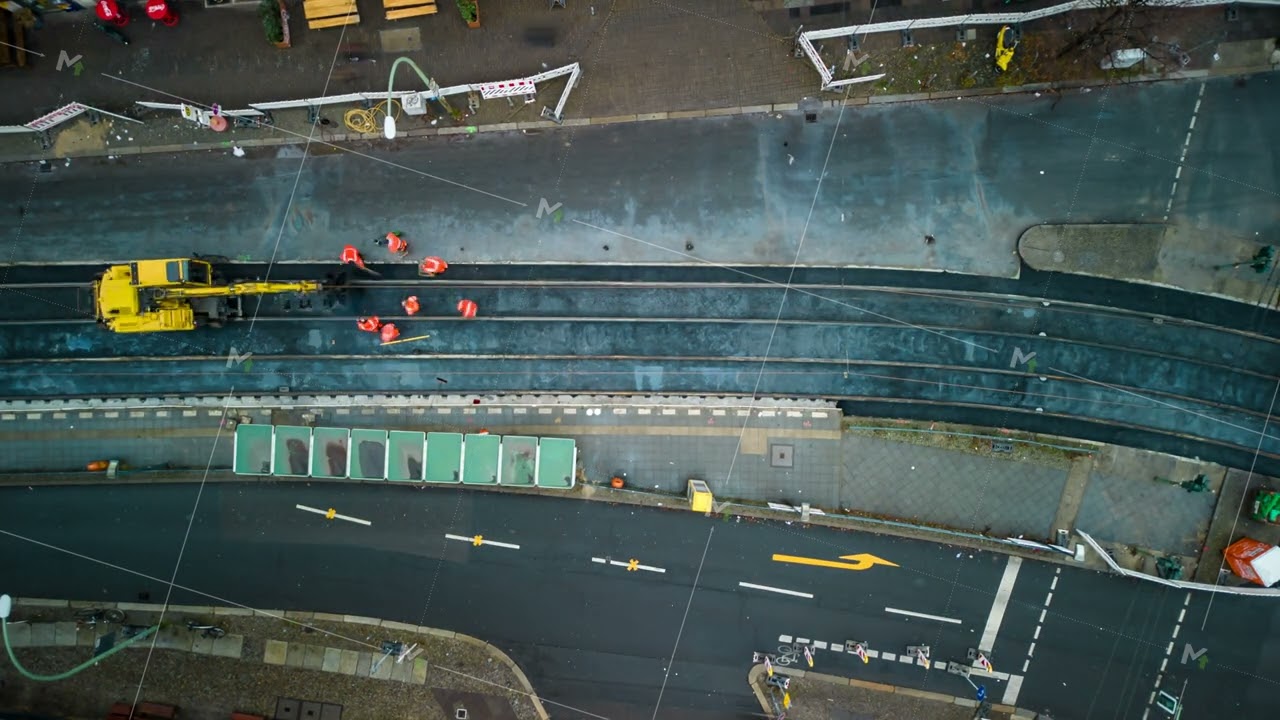 Top down hyperlapse shot of building transport infrastructure. Workers repairing asphalt surface on