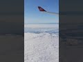 The power of zooming in and watching the distant plane       flighttravel above the clouds