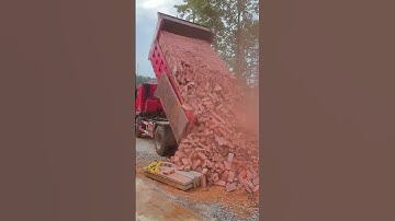 The process of unloading red bricks from a truck