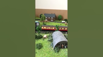 Weathered Ivatt 2mt passing the Nissen hut with collet coaches