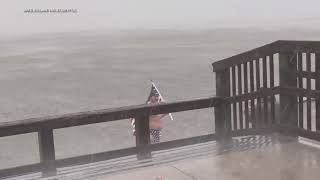 Florida man waves American flag as Milton Rolls in