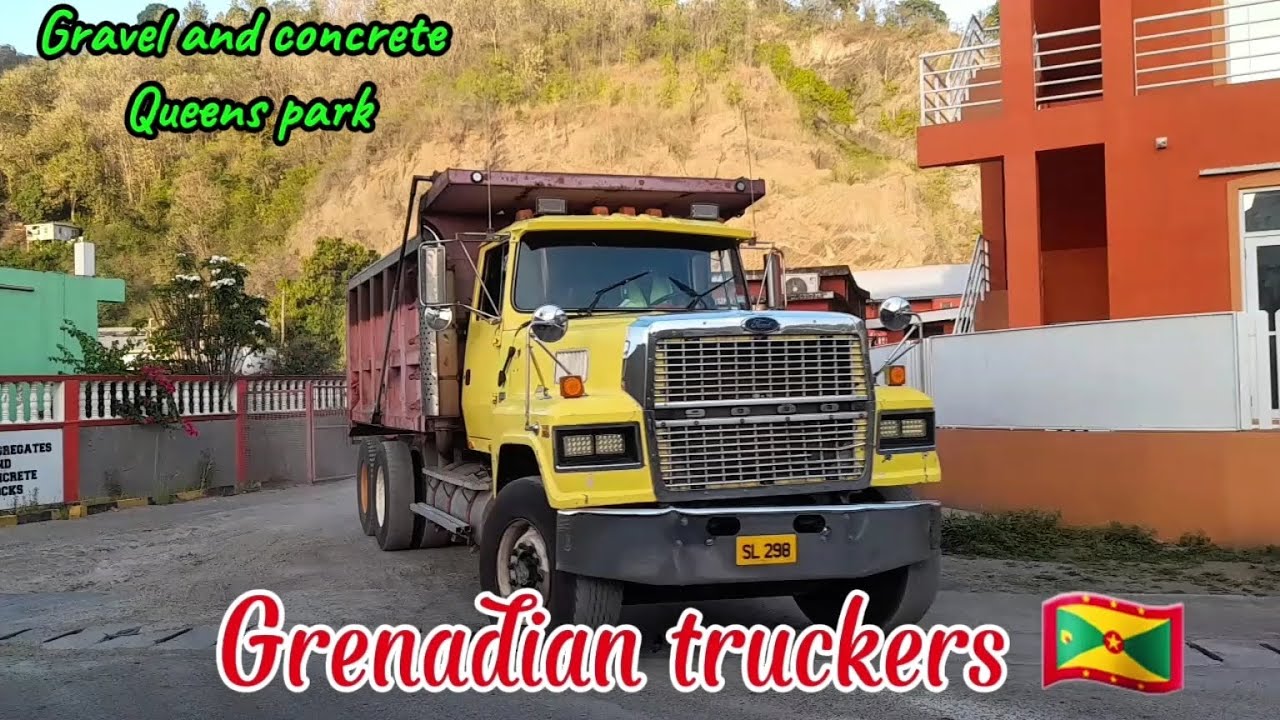 Grenadian truckers offload sand in gravel and concrete 
