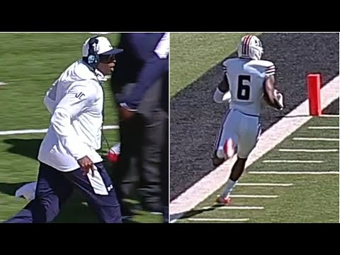 Jackson State coach Deion Sanders runs with his receiver Baldwin on 64-yard touchdown